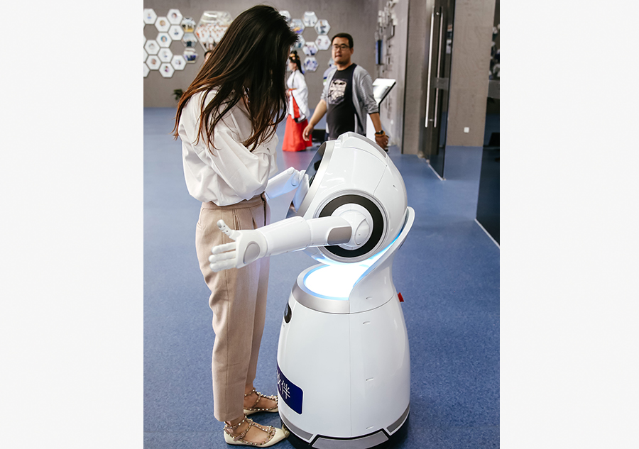 Hugging, calligraphy writing robots featured in Yuyao