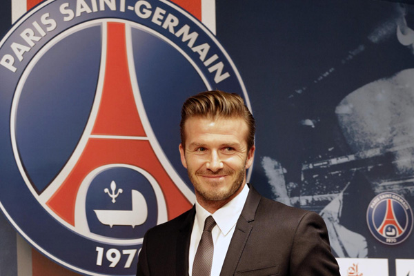 David Beckham arrives for a news conference in Paris