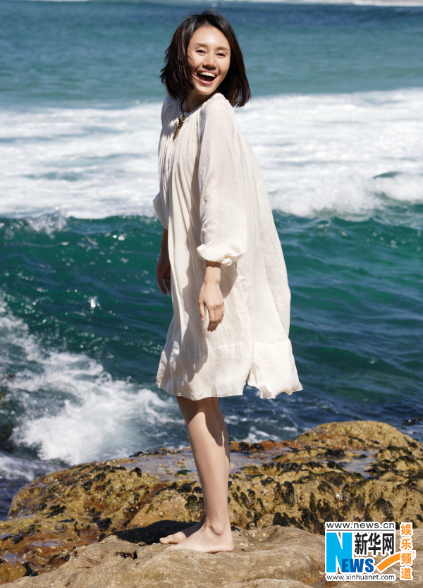 Actress Yuan Quan poses on beach