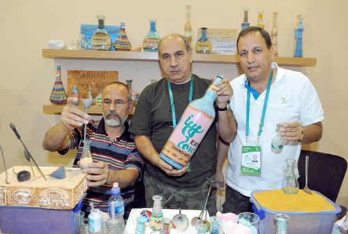 Brothers make sand art bottles at Expo