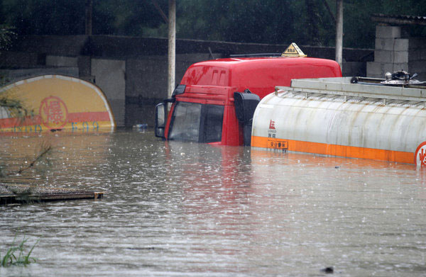 Rainstorm floods chemical storage tanks