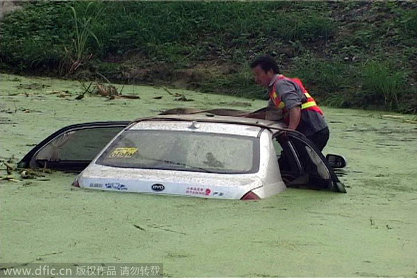 Calm driver waits on top of sinking car for help