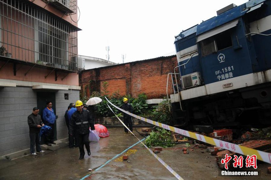 Derailed train crashes into residences in South China