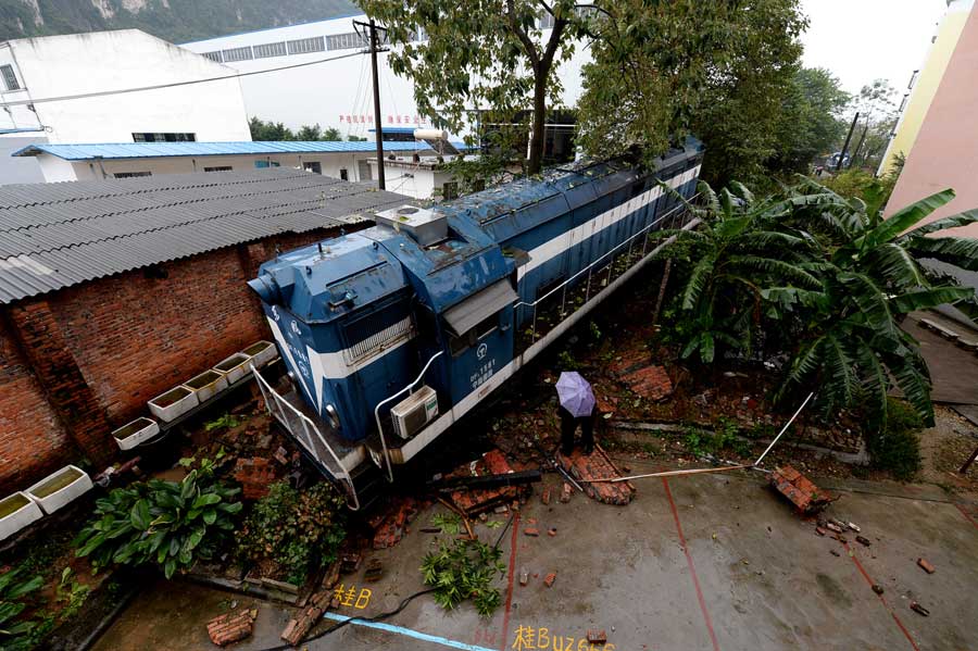 Derailed train crashes into residences in South China