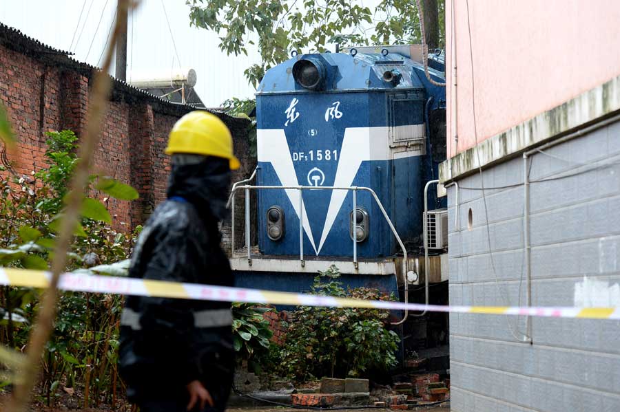 Derailed train crashes into residences in South China