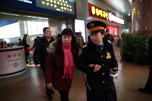 Railway station workers enjoy happy crowds of travelers