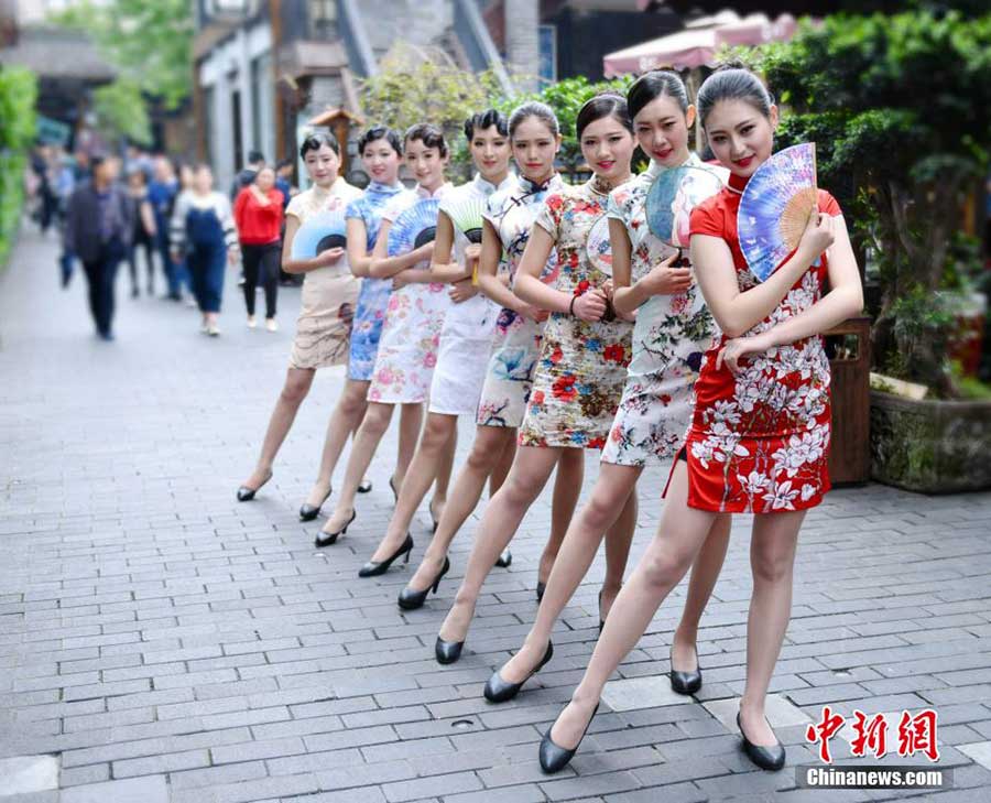 Stewardesses-to-be present traditional <EM>Qipao</EM> in SW China