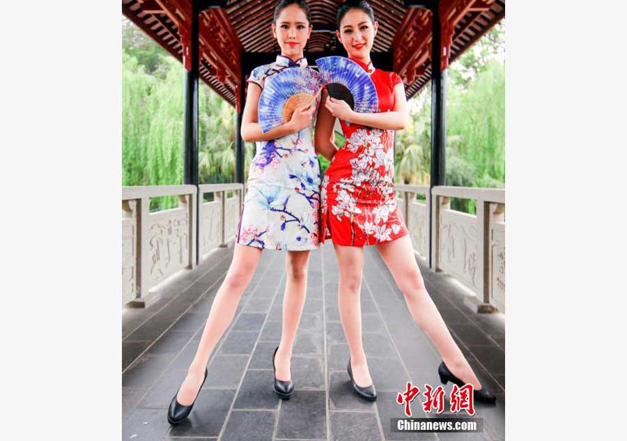 Stewardesses-to-be present traditional <EM>Qipao</EM> in SW China