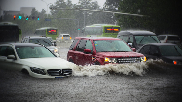 Beijing issues orange alert for heavy rain, train, flights delayed