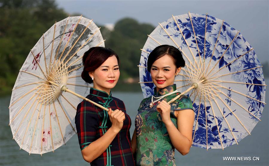 Ladies present <EM>qipao</EM> in South China's Guangxi