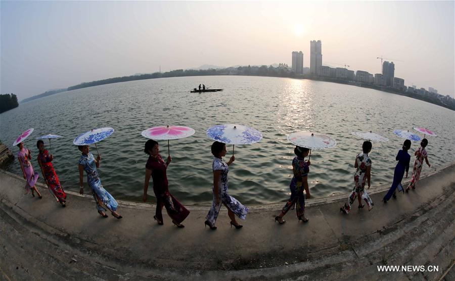 Ladies present <EM>qipao</EM> in South China's Guangxi