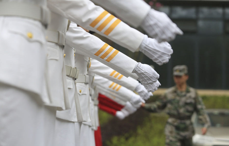 Marching in step: Female college students form flag-raising team