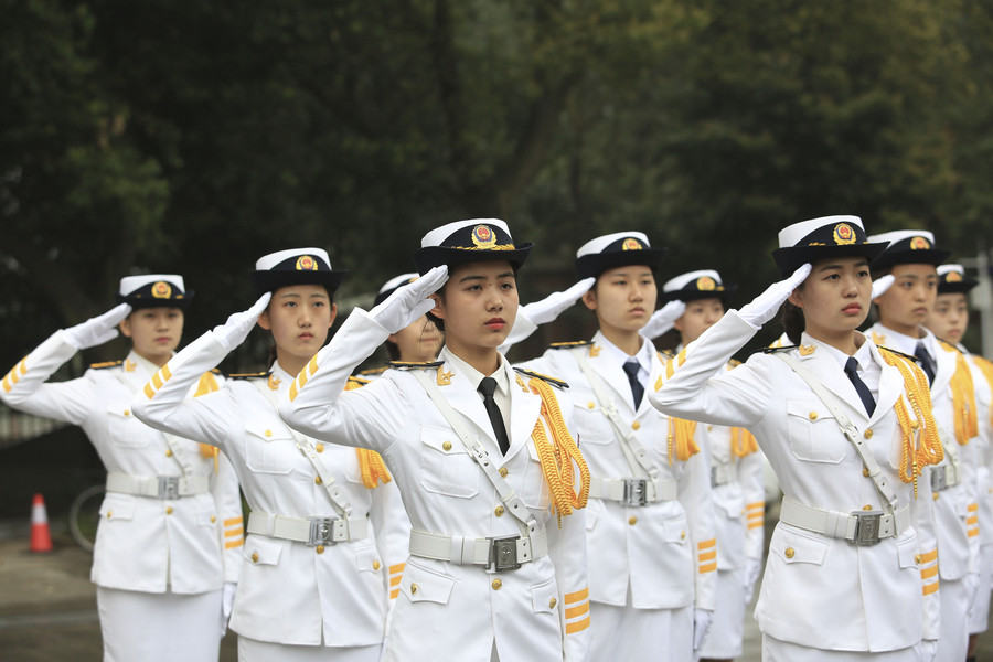 Marching in step: Female college students form flag-raising team