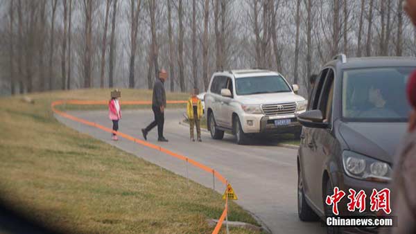 Tourists get out of car in Tiger Area at Beijing Wildlife Park