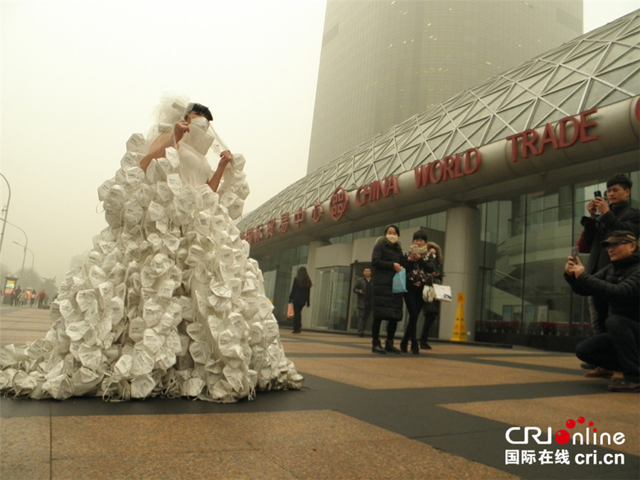 Artist appeals to public to combat smog with respirator wedding dress