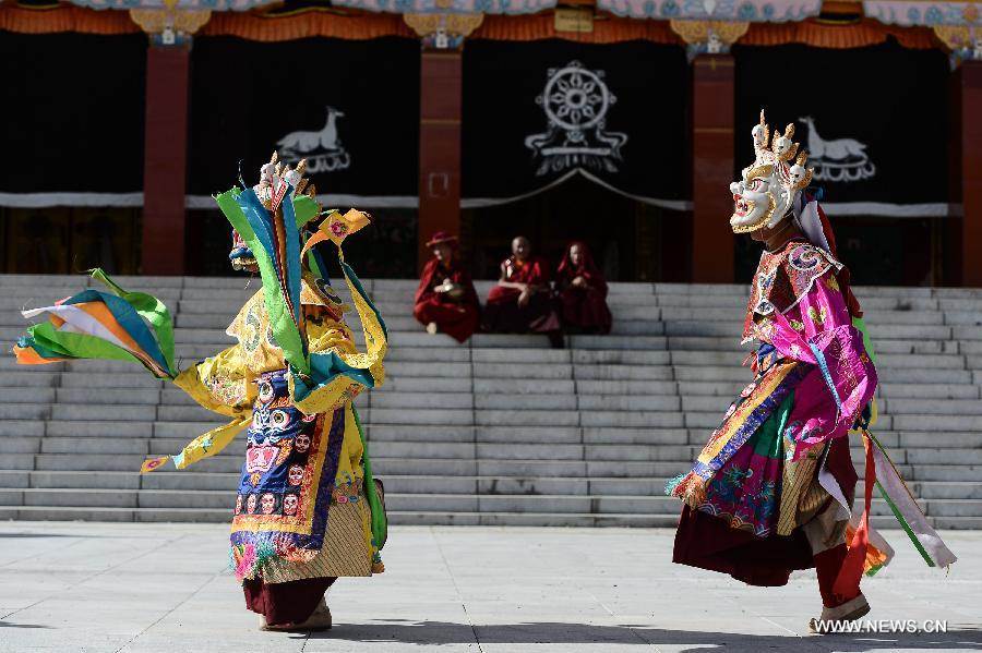 Monks wearing masks rehearse Gesar opera at Chalang Temple in NW China