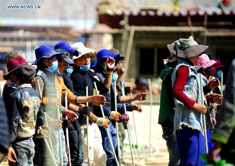 Craftswomen repair roof of Tibet monastery