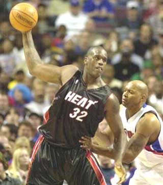 Miami Heat center Shaquille O'Neal (32), guarded by Detroit Pistons forward Derrick Coleman, looks to pass during the second quarter at the Palace in Auburn Hills, Mich., Friday, Nov. 26, 2004.