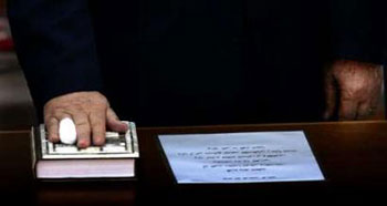 Mahmoud Abbas places his right hand on the Muslim Holy book the Koran, as he is sworn in as Palestinian president to succeed Yasser Arafat in Ramallah, January 15, 2005. Abbas was sworn in as Palestinian president on Saturday, but his call for a ceasefire was overshadowed by fresh violence in Gaza and Israel's decision to cut ties over a deadly militant attack. 'Our hand is extended towards an Israeli partner for making peace,' Abbas said. 'Peace can only be achieved by working together to reach a permanent status solution,' he said, restating his support for a U.S.-backed peace 'road map' that calls initially for militants to be reined in while Israel eases its occupation. [Reuters]