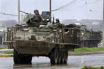 U.S. Army 1st Battalion, 24th Infantry Regiment soldiers steer their Stryker combat vehicles toward insurgents during a fire fight in Mosul, Iraq Sunday, Feb. 6, 2005. Their convoy was attacked by insurgents firing rocket-propelled grenades, mortars and small arms. There were no casualties. [AP] 