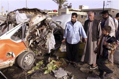 Ziad Mohammed Jassim stands next to the wreck of his car, that he claims was smashed by a U.S. armoured vehicle in Ramadi, an insurgent stronghold 113 kilometers (70 miles) west of Baghdad, Iraq, Wednesday, March 2, 2005, though the claim could not be verified. Clashes erupted between U.S. forces and gunmen after insurgents detonated a roadside bomb as a U.S. convoy passed. The explosion missed the convoy, but damaged two civilian cars that were in flames. [AP]