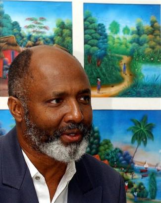 Rev. Gerard Jean-Juste speaks during the national conference on The Future of Haiti's Political Process at the Moulin Sur Mer resort near Montrouis, Haiti, 60 kilometers (37 miles) north of Port-au Prince, Thursday, March 3, 2005. Representives of the policital parties were meeting to discuss the electorial process leading up to Haiti's presidential elections in November of 2005. [AP]