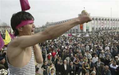 A Kyrgyz man shouts anti-President Askar Akayev slogans as he and other opposition protesters rally in Bishkek, Kyrgyzstan, Thursday, March 24, 2005. Protesters stormed the government and presidential compound in Kyrgyzstan on Thursday, entering the building after clashing with riot police who had surrounded it during a large oppositon rally and march. (AP 