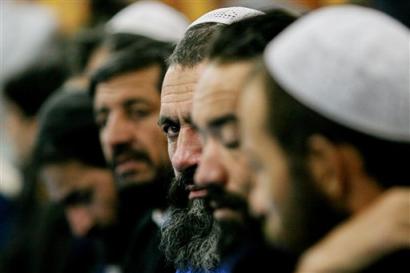 Afghan prisioners released from Guantanamo are handed over during a ceremony at the Afghan Supreme Court in Kabul, Afghanistan, Tuesday, April 19, 2005. Seventeen Afghan men released from the U.S. detention center for terror suspects in Guantanamo Bay were turned over to local authorities in the capital on Tuesday and will be allowed to return home soon. (AP