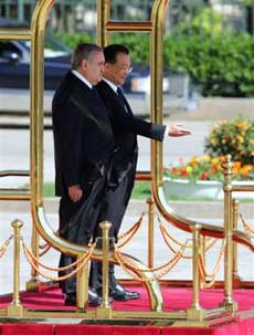 Chinese Premier Wen Jiabao, right, leads the way for French Premier Jean-Pierre Raffarin during a welcome ceremony in Beijing's Tiananmen Square Thursday April 21, 2005. Raffarin is on a three day trip to China to promote commercial ties and affirm French support for ending a nearly 16-year-old European arms embargo on Beijing. China later signed contracts to buy five Airbus A380 super-jumbo jets and other French goods in deals worth more than euro 3 billion (US$4 billion). 