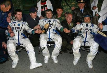 Italian ESA astronaut Roberto Vittori, left, Russian cosmonaut Salizhan Sharipov, center, and American NASA astronaut Leroy Chao shake hands shortly upon their arrival to the town of Arkalyk, northern Kazakhstan, early Monday, April 25, 2005. Chao and Sharipov returned to earth after a half-year stint on the International Space Station while Vittory spent 10 days at the station after arriving with a replacement crew. (AP