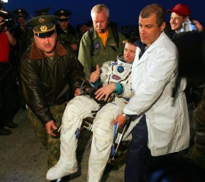 Russian ground personal members and doctors carry Italian ESA astronaut Roberto Vittori to the medical tent upon his arrival to the town of Arkalyk, northern Kazakhstan, early Monday, April 25, 2005. American NASA astronaut Leroy Chao and Russian cosmonaut Salizhan Sharipov safely landed to earth after a half-year stint on the International Space Station while Italian ESA astronaut Roberto Vittori spent 10 days at the station after arriving with replacement crew. (AP