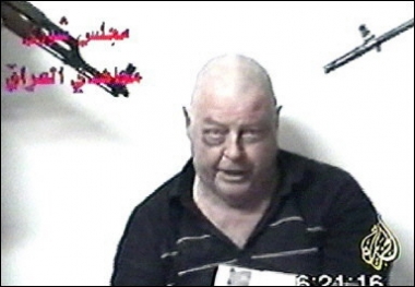 An image taken from a video shown on Qatari-based al-Jazeera news channel shows Australian hostage Douglas Wood pleading for his life in Iraq as two men point guns at his head. An Australian Muslim leader left for Iraq to try to negotiate his release, a day before the expiry of a deadline set by the hostage-takers for Canberra to start withdrawing its troops(AFP/AL JAZEERA TV/file)