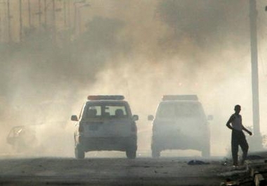 Iraqi police respond to a car bomb attack in eastern Baghdad May 29, 2005. Two suicide car bomb attacks in Baghdad, one near the Oil Ministry and the other targeting a police patrol, killed at least six Iraqis, police said. Iraq's al Qaeda wing claimed in an Internet posting the attack near the Oil Ministry. REUTERS