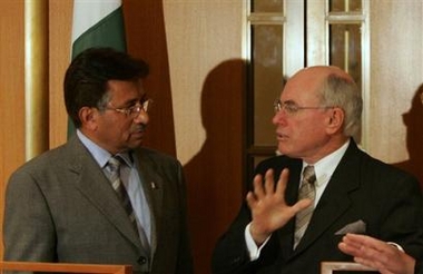 Pakistan's President Gen. Pervez Musharraf, left, and Australia's Prime Minister John Howard, right, chat after they witnessed the signing of a memorandum of understanding on cooperation to combat terrorism at Parliament House in Canberra, Australia, Wednesday, June 15, 2005. (AP