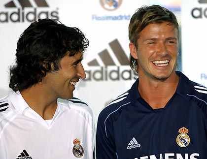 Real Madrid's David Beckham (R) and captain Raul smile as they pose during the presentation ceremony of the team's new kit for the upcoming season at Santiago Bernabeu stadium July 13, 2005.