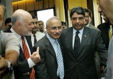 Indian Home Secretary VK Duggal, right, Pakistan Interior Secretary Syed Kamal Shah, center, and Pakistan Ambassador to India Aziz Ahmed Khan leave after announcing a joint statement following their talks in New Delhi, India, Tuesday, Aug. 30, 2005. 