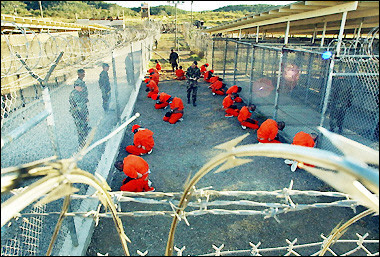 In this January 2003 US Navy photo, Al-Qaeda and Taliban detainees sit in a holding area at Camp X-Ray at Naval Base Guantanamo Bay, Cuba. 