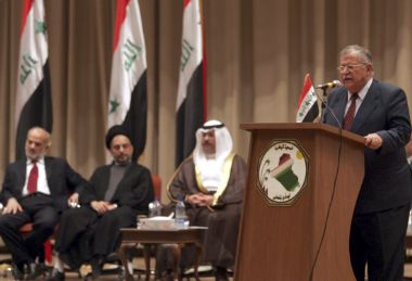 Iraq’s President Jalal Talabani (R) gives a speech during a special session of the Iraqi National Assembly in Baghdad's green zone October 12, 2005. Iraqi leaders amended a draft constitution on Wednesday just three days before it goes to a referendum but many minority Sunnis rejected the compromise and insurgents struck again, killing some 30 in a suicide bombing. Also present are (L-R) Iraq’s Prime Minsiter Ibrahim Jaafari, Shiite cleric Abdul-Aziz al-Hakim, head of the Supreme Council for the Islamic Revolution in Iraq and Iraq’s Vice President Ghazi al-Yawar.