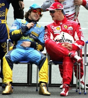 New Formula One World Champion Fernando Alonso, left, chats with 2004 World Champion Michael Schumacher during a group photo session before the Chinese Grand Prix in Shanghai, China, Sunday Oct. 16, 2005. (AP