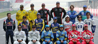 Formula One drivers pose for a team photo before the start of the Chinese Grand Prix in Shanghai October 16, 2005. Front row (L-R) Juan Pablo Montoya, Kimi Raikkonen, Giancarlo Fisichella, Fernando Alonso, Michael Schumacher and Rubens Barrichello. Middle row (L-R) David Coulthard, Christian Klein, Jenson Button, Takuma Sato, Jarno Trulli, Antonio Pizzonia and Mark Webber. Back row (L-R) Narain Karthikeyan, Tiago Monteiro, Christijan Albers, Robert Doornbos, Jacques Villeneuve and Felipe Massa. Missing are Ralf Schumacher and Nick Heidfeld. 