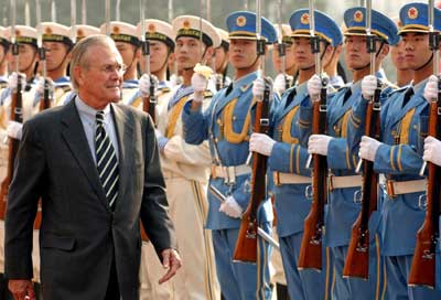 qU.S. Defense Secretary Donald Rumsfeld (L) reviews an honour guard during a welcome ceremony at the Defense Ministry's Bayi Building in Beijing October 19, 2005. China can dispel global worries about its strategic intentions and ensure future prosperity by opening up its political system, Rumsfeld told future Chinese leaders on Wednesday.