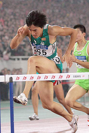 Olympic gold medallist Liu Xiang of China reacts after winning the final of the 110-meter hurdles at the 10th National Games of the People's Republic of China in Nanjing. 