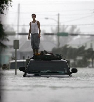 A Key West resident stands on the roof of his truck after Hurricane Wilma hits Florida's southern west coast October 24, 2005.