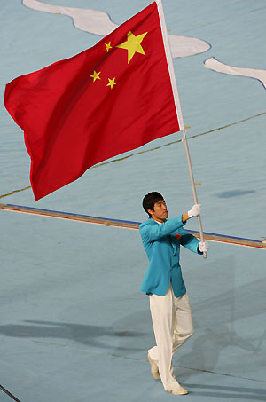 Olympic gold medallist Liu Xiang carries his country's flag while entering the field during the opening ceremony of the 4th East Asian Games in Macau October 29, 2005. The regional sporting event, which hosts nine countries and regions, will be held from October 29 through November 6.