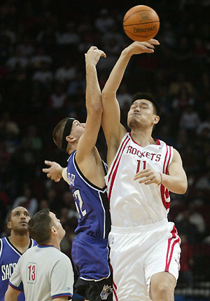 Houston Rockets center Yao Ming goes up against Sacramento Kings center Brad Miller for the opening tip-off of their NBA game, the first of the regular season November 2, 2005 in Houston.