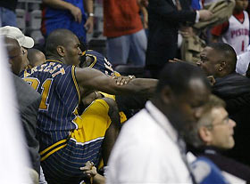 Indiana Pacers' Ron Artest is restrained by Austin Croshere before being escorted off the court following their fight with the Detroit Pistons and fans in this Nov. 19, 2004 photo, in Auburn Hills, Mich.