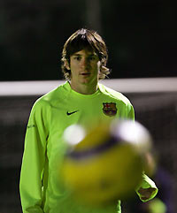 Barcelona's Argentinian player Lionel Messi looks at the ball during a training session at the Nou Camp stadium in Barcelona November 17, 2005.