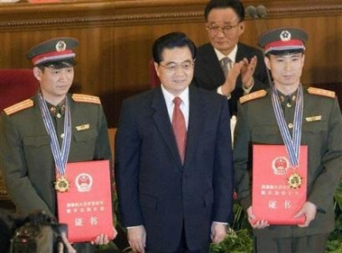 Chinese astronauts 
 Fei Junlong (R) and Nie Haisheng (L) pose with Chinese President Hu Jintao (Center) after receiving recognition during a ceremony to mark the successful conclusion of October's Shenzhou VI manned mission in the Great Hall of the People in Beijing, China, Saturday, Nov 26, 2005. [AP]