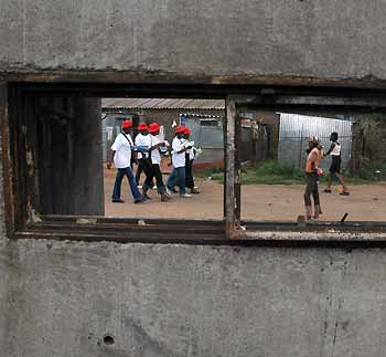 Health care workers speak to residents during a door to door AIDS awareness campaign in Soweto township near Johannesburg, November 29, 2005.