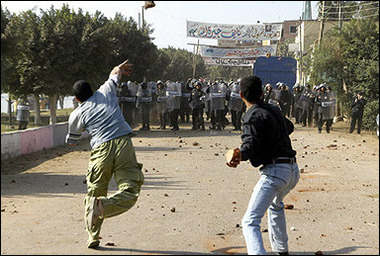 Residents of the Aziziyah village in Zagazig City clash with the police as they try to enter a sealed off voting station. 